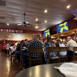 people sitting at tables in a restaurant