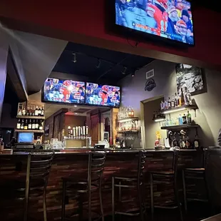 bar seating and televisions