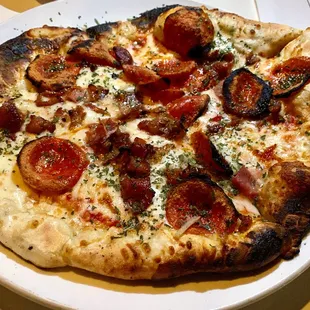 The Little Piggies Pizza with pepperoni, bacon, prosciutto and a flour crust