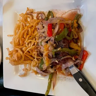 "Flat Iron" Rickenbacker steak topped with sauteed onions, peppers, and mushrooms and finished with a garlic butter sauce.