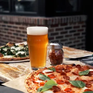 two pizzas and a glass of beer