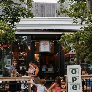 people walking in front of a restaurant