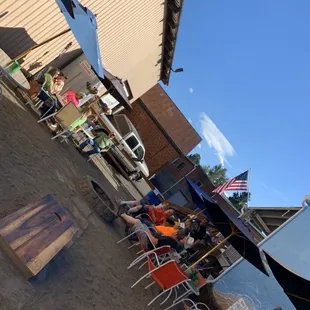 people sitting at tables on the beach
