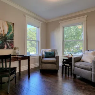 a living room with two chairs and a table