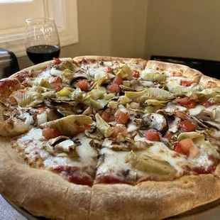 12 slice pizza with tomato, mushroom, and artichoke