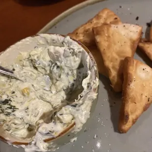 Half eaten dip and pitas