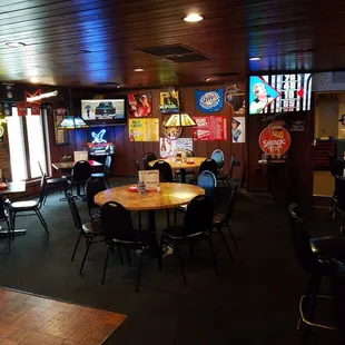 a restaurant with tables, chairs, and televisions