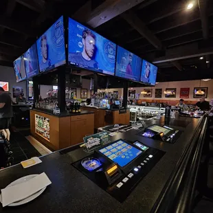 a bar with a lot of tv screens