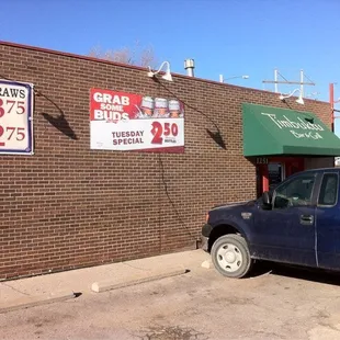 a truck parked in front of a restaurant