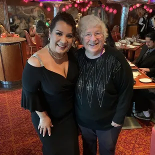 Neighbors taking a picture on Gala night on the cruise ship.