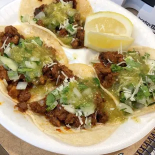 Al Pastor tacos with cilantro and onions, green salsa, and lemons. Exquisite!