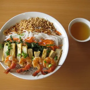 a bowl of food with shrimp and rice