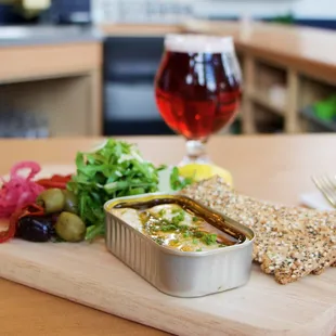 Tinned Fish board with olives, almonds, and pickled egg