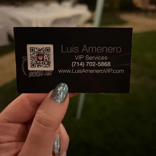 a person holding up a business card