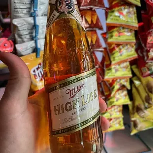 a person holding a bottle of beer