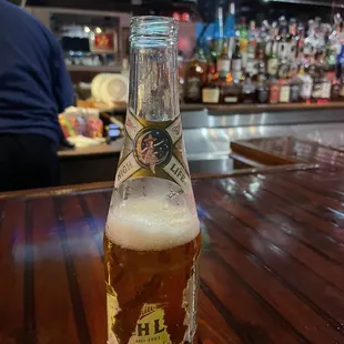 a bottle of beer on a bar