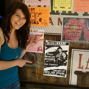 a woman standing in front of a bulletin board