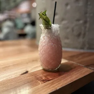 a pink drink on a wooden table