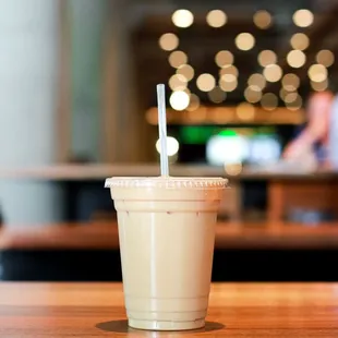 a coffee cup with a straw