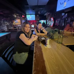 two women sitting at a bar
