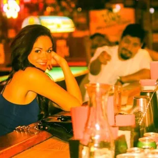 a woman sitting at a bar