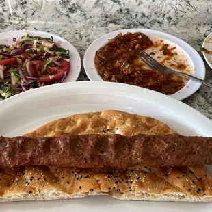 Adana kebab is served with fresh sides