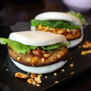 two buns on a black plate