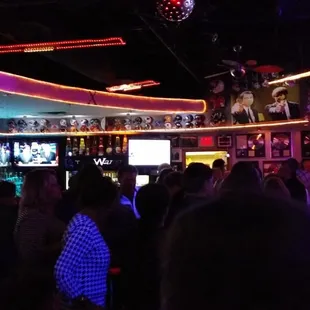 a crowd of people at a bar