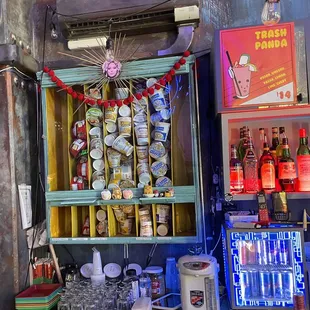 a bar with a shelf full of drinks