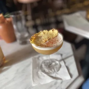 a cocktail with a pineapple garnish