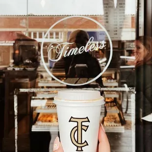 a person holding a cup of coffee