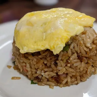Side fried rice topped with a soft scrambled egg.