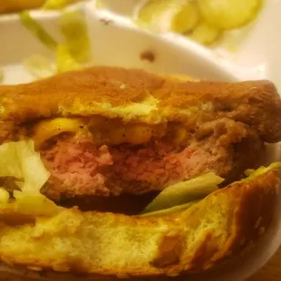 a hamburger and french fries in a styrofoam container