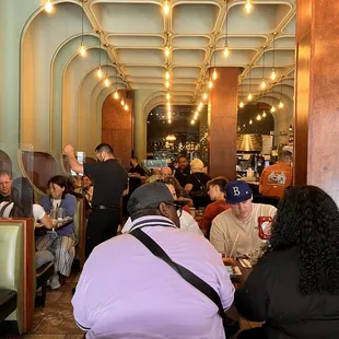 people sitting at tables in a restaurant