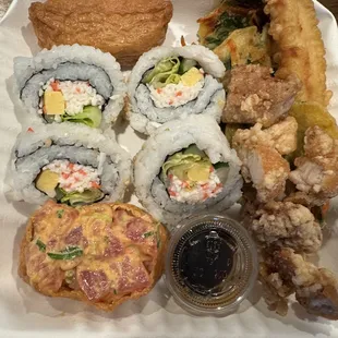 a plate of sushi and rolls