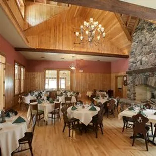 a dining room with a stone fireplace