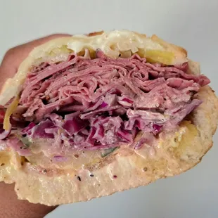 #8 1/2 pound of Pastrami, Swiss cheese, sauerkraut, house slaw, house dressing on Dutch Crunch bread