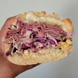 #8 1/2 pound of Pastrami, Swiss cheese, sauerkraut, house slaw, house dressing on Dutch Crunch bread