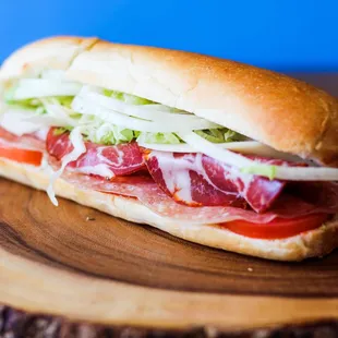 a sub sandwich on a wooden board