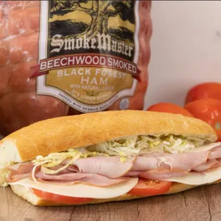 a ham sandwich with lettuce and tomatoes