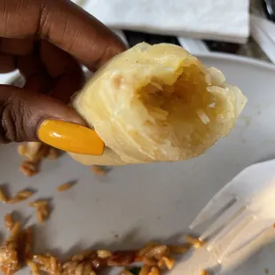 a person holding a piece of food