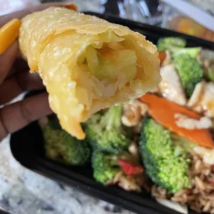 a person holding a piece of food