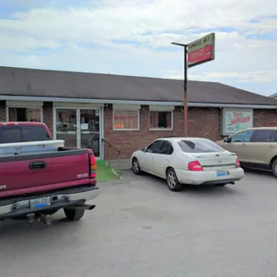 two cars parked in front of a restaurant