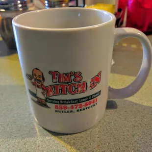 tim&apos;s kitchen logo on a coffee mug