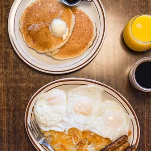 a breakfast of pancakes, eggs, and hash browns