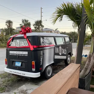 a van with a red ribbon tied to it