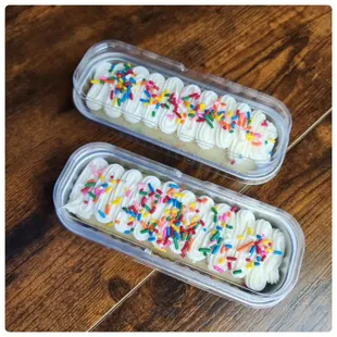 two tin cakes with sprinkles