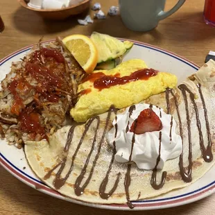Large Appetite with a strawberry banana crepe, scrambled eggs with cheese, hash browns and fruit.