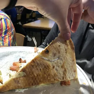 Twist tie stuck in our pizza