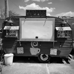 a black and white photo of a coffee truck